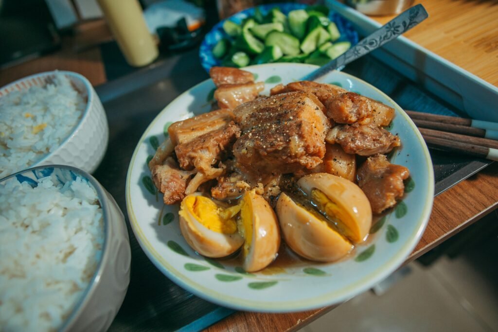 pexels-photo-6525933-6525933 A Delicious Pork Adobo with Hard Boiled Eggs in a Bowl Beside Rice