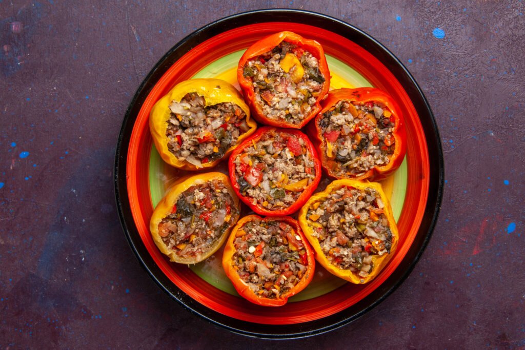 top-view-cooked-bell-peppers-with-ground-meat-grey-surface-food-beef-dolma-vegetables-meal